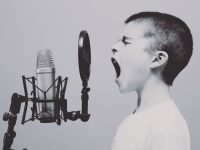 boy singing on microphone with pop filter music streaming comparison,smartphone music apps,youtube music vs pandora