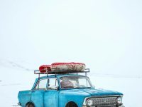blue sedan on snow ground android auto, whatsapp, car dashboard