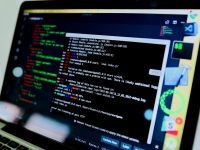 laptop compute displaying command prompt youtube editor, adding end screen, video uploading