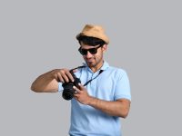 a man holding a camera field technician, scheduling, mobile device