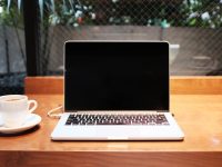 laptop computer beside coffee mug discord password change settings menu computer phone
