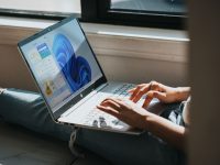 person using Windows 11 computer on lap powershell wsl, command prompt, restart linux, windows 11 terminal