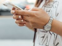 woman holding iPhone during daytime snapchat user, phone screen, avoiding spotlight