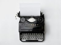 black Fayorit typewriter with printer paper snapchat app interface, story section, user interaction
