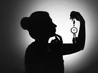 silhouette of man holding magnifying glass person search, whitepages, identity check