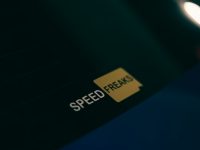A close up of a speed freak sticker on a car website speed, ai technology, performance optimization