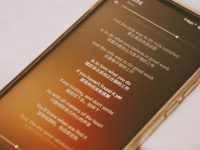 black android smartphone on white table voice assistant, reading text, subtitles screen