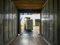 yellow and black forklift during daytime shipping center, warehouse, delivery package