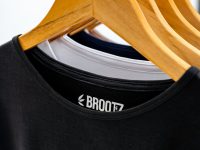 10 Logo Makers With Ready-To-Use Social Calendars a black speaker with a wooden handle clothing drop, fashion website, ecommerce branding