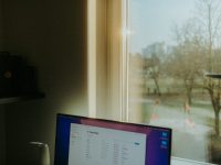 AggregatorHost.exe Explained: Safe or Malware? a laptop computer sitting on top of a desk windows task manager, background processes, office pop up