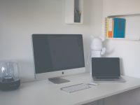 silver iMac beside MacBook Pro windows mobility center, presentation mode on, laptop settings