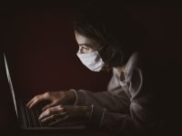 woman in black long sleeve shirt using laptop computer antivirus warning, security software, quarantine folder