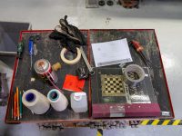 a group of objects on a table dj speaker, cleaning gear, microfiber cloth