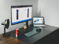 a laptop and a desktop computer on a desk workflow optimization, productivity setup, dual screen