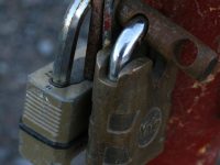 a red fire hydrant with two padlocks attached to it ssh key, terminal error, authentication agent
