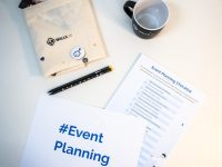 a table with a coffee cup, notepad, pen, and envelope roadmap planning, strategy meeting, product management