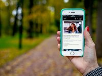 iPhone 6 displaying woman wearing blue jacket depop app, online marketplace, fashion resale