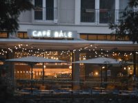 A restaurant with tables and umbrellas outside at night cafe homepage, modern restaurant site, mobile responsive design