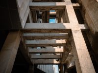 Fire-resistant prefab home materials 101 A very tall building with a bunch of windows fiber cement siding construction modern home