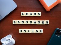 scrabble tiles spelling learn languages on a table language learning app, duolingo interface, drops app