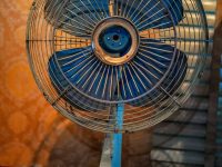 a blue fan sitting on top of a rug corsair aio cooler rgb fans