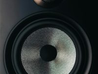 black and gray speaker on brown wooden table alexa speaker loud volume angry face