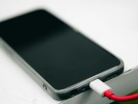 a cell phone is plugged into a charger iphone charging cable, magSafe, fast charge, battery health