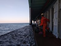 Oil rig occupations: A Guide to Different Offshore Roles man in red jacket and blue denim jeans standing on dock during daytime oil rig workers, offshore crew, derrick tower