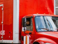 red and white truck in front of orange wall trucker compliance eld dashboard