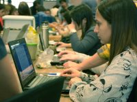 woman browsing laptop beside table digital classroom, students, computer learning
