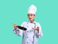 a young boy in a chef’s uniform holding a knife chef kitchen tablet cost analysis