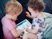 two toddlers sitting on sofa while using tablet computer kids social apps tablet safety