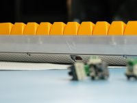 A group of toy cars sitting on top of a table router reset button close up, person pressing reset pin, home wifi router on desk