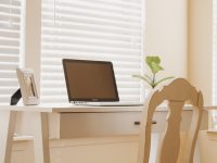 Starting Your Online Business as a Reseller in 2026 a laptop computer sitting on top of a wooden desk online reseller workspace laptop inventory boxes modern home office