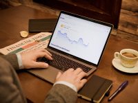 YourAssistantLive.com AI Assistant Guide: Real-Time AI Productivity and Business Support Tools Explained a person typing on a laptop on a table ai assistant dashboard, business productivity tools, real time analytics