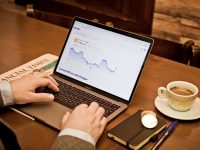 a person using a laptop on a wooden table ai assistant dashboard, business productivity tools, real time analytics