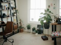 Which Tools Are Most Popular for Designing Team Sportswear with Logos? a room with a desk, chair, bookshelf and a potted plant online reseller workspace laptop inventory boxes modern home office