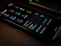 black remote control on brown textile smartphone video editing app interface, timeline editor, vertical video editing screen, content creator workspace