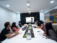 Comprehensive 6 YesMovies Alternatives To Watch Free Movies And TV Shows Online In 2024 people sitting at the table looking to another person standing in front of them laptop screen seo dashboard shared workspace people working