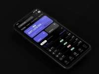 A close up of a cell phone on a black surface visual app builder interface, backend dashboard panels, mobile app design screen