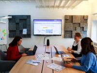 a group of people sitting around a conference table internal dashboard interface, business analytics screen, team collaboration tool