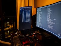 A man sitting in front of a computer monitor linux terminal nativefier installation command screen