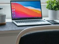 macbook pro on white table windows settings screen, account management, work or school connection