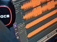 black and red headphones on black computer monitor game audio editing interface waveform, game engine inspector panel, sound file icons