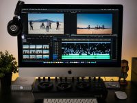 black flat screen computer monitor podcast editing software interface, audio waveform screen, desktop recording setup