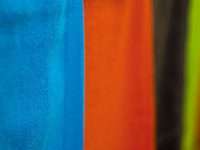 orange blue and white textile felt fabric texture close up, colorful puppet material, soft fibers