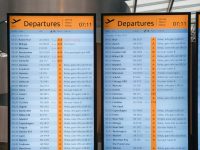 A couple of signs that are in a building airline booking system dashboard, travel technology interface, reservation management screen