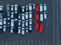 Aerial view of a parking lot with many cars. car rental fleet parking lot aerial view, rental cars lined up, vehicle inventory management