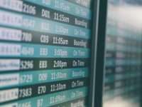 Airline Revenue Management Tools Like PROS For Optimizing Ticket Pricing Airport departures timetable showing Delta and Alaska Airlines flights on time and boarding airline revenue dashboard, pricing analytics screen, flight demand chart
